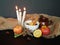 Autumn background with apples, pear, dried herbs, anise, cinnamon sticks, a cup of tea, candles, sackcloth.