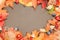 Autumn background with beautiful leaves, rosehips, walnuts, forest mushrooms on an old dark table. Mockup for seasonal offers and