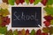 Autumn background. Blackboard and chalk. Inscription school.