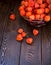 Autumn background. Bright orange physalis berries on a brown woody background. Background for the autumn holidays and thanksgiving