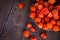 Autumn background. Bright orange physalis berries on a brown woody background. Background for the autumn holidays and thanksgiving