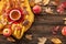 Autumn background concept - red cup of black tea, dried leaves, red apples, chocolate donut on a wooden background with copy space