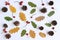 Autumn background. Creative flat layout of autumn colorful leaves, cones and rosehips on white table background. Fall decorative c