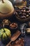 Autumn background with decorative pumpkin, corn, wallnuts, autumn leaves, acorns on dark stone table