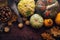 Autumn background with decorative pumpkin, corn, wallnuts, autumn leaves, acorns on dark stone table