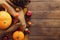 Autumn background with fallen leaves, fabric and pumpkins on rustic wooden table. Thanksgiving day concept. Flat lay, top view,