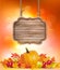 Autumn background with fruit and leaves and wooden sign.
