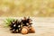Autumn background with pine cones and oak acorns on wooden board against bokeh backdrop