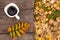 Autumn background or postcard. Coffee in white mug, on wooden bench. Autumn leaf