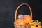 Autumn background with seasonal berries, pumpkins in a basket and autumn nature flowers on black boards, mouse toy on a pumpkin,