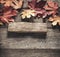 Autumn background with signboard, orange leaf on old grunge wood deck, copy place for inscription, Top view, tablet for text