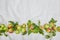 Autumn background of small apple and leaves on biege linen textile background. Empty space for text. Top view.