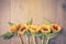 Autumn background with sunflowers on wooden board. View from above. Retro filter effect
