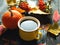 Autumn background for thanksgiving or seasonal holiday. Coffee mug, pumpkin and colorful leaves