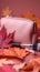 Autumn beauty essentials Pink leather clutch, makeup brushes, and leaves