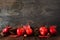 Autumn border of apples, leaves, and fall decor, side view on a dark stone background