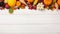 Autumn Bounty: Harvest and Thanksgiving Background with Fruits and Gourds on a White Wooden Table