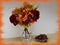 Autumn bouquet in a glass vase and chestnuts in a bowl