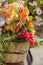 Autumn bouquet with grape and fogliage, basket on bike closeup