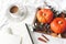 Autumn breakfast in bed composition. Blank card, notebook mockup. Cup of coffee., eucalyptus leaves and pumpkins on