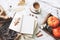 Autumn breakfast in bed composition. Card, notebook mockup. Cup of coffee, eucalyptus leaves, pumpkins on wooden tray