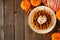 Autumn breakfast pumpkin spice waffle. Above view table scene on a dark wood background.