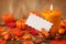 Autumn candles and blank note