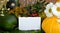 Autumn card. Pumpkin among wild flowers are on the table. Notepad with a blank field for writing text. Autumn card