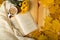 Autumn charm, chrysanthemum, book and warm scarf in leaves