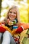 Autumn cheerful young girl sitting park fall