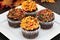 Autumn chocolate cupcakes with orange and chocolate frosting and