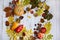Autumn circular layout of pumpkins, apples, peppers, leaves, cinnamon and berries on a light wooden background