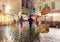 Autumn in city  people walk under umbrella in rainy evening city walk medieval stree blurred light light in Tallinn old town yello