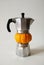 Autumn coffee concept. Moka pot with small orange pumpkin. Isolated