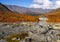 Autumn colorful tundra on the background mountain peaks in cloudy weather. Mountain landscape in Kola Peninsula, Arctic