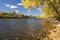 Autumn colors along the Mississippi River, Minneapolis skyline in the distance.