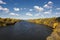 Autumn colors along the Mississippi River, Minneapolis skyline in the distance.