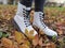 Autumn colors. Close up of beautiful white modern lace-up shoes. A walk on fallen leaves and green grass.