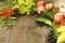 Autumn composition of bright juicy leaves, pears, rowan berries, apples on a brown dark wooden background.