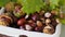 Autumn composition - chestnuts, acorns and oak leaves in a wicker basket.