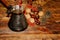 Autumn composition. Clay turka, pine cones, berries, walnuts, chestnuts on wooden Dark rustic background