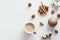 Autumn composition with coffee cup, acorns, candle, cotton on white background. Flat lay, top view. Nordic, hygge, cozy home