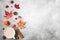 Autumn composition. Coffee cup, autumn leaves, flowers, berries, nuts on concrete background