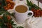 Autumn composition: coffee mug with rowan berries