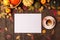 Autumn composition with cup of coffee, pumpkins, apples, nuts and cinnamons on dark rustic wooden background