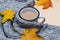 autumn composition, cup of coffee, sweater, yellow leaves