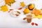 Autumn composition with cup of hot drink, delicious apple strudel   and colorful fall leaves on white background. Copy space.