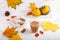 Autumn composition with cup of hot drink, delicious apple strudel   and colorful fall leaves on white background. Copy space.