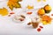 Autumn composition with cup of hot drink, delicious apple strudel   and colorful fall leaves on white background. Copy space.