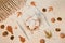 Autumn composition with a cup of meringues, yellow leaves, chestnuts, walnuts and wool blanket on a white wooden background